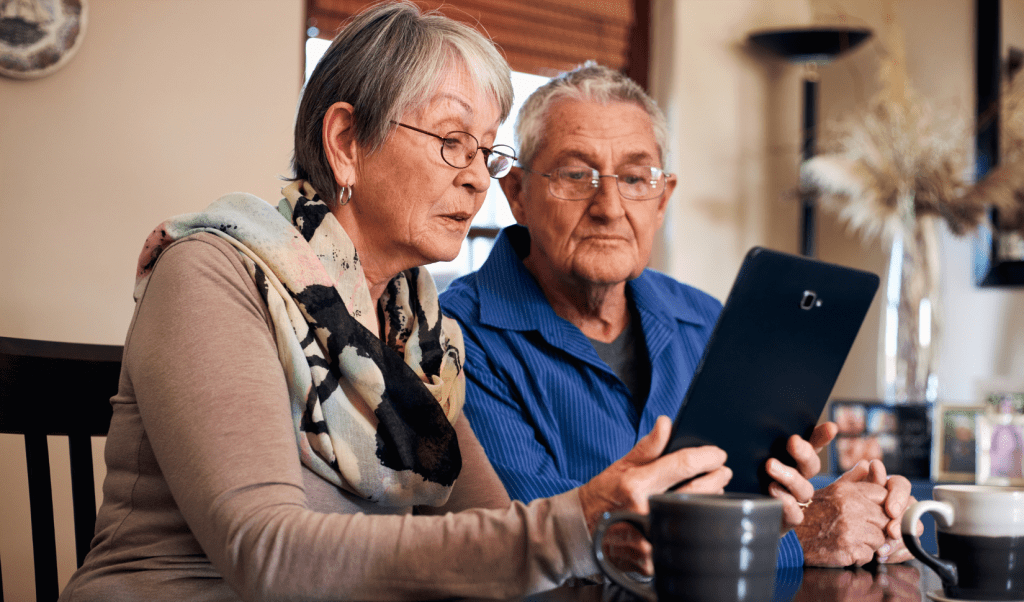 a couple looking at a tablet